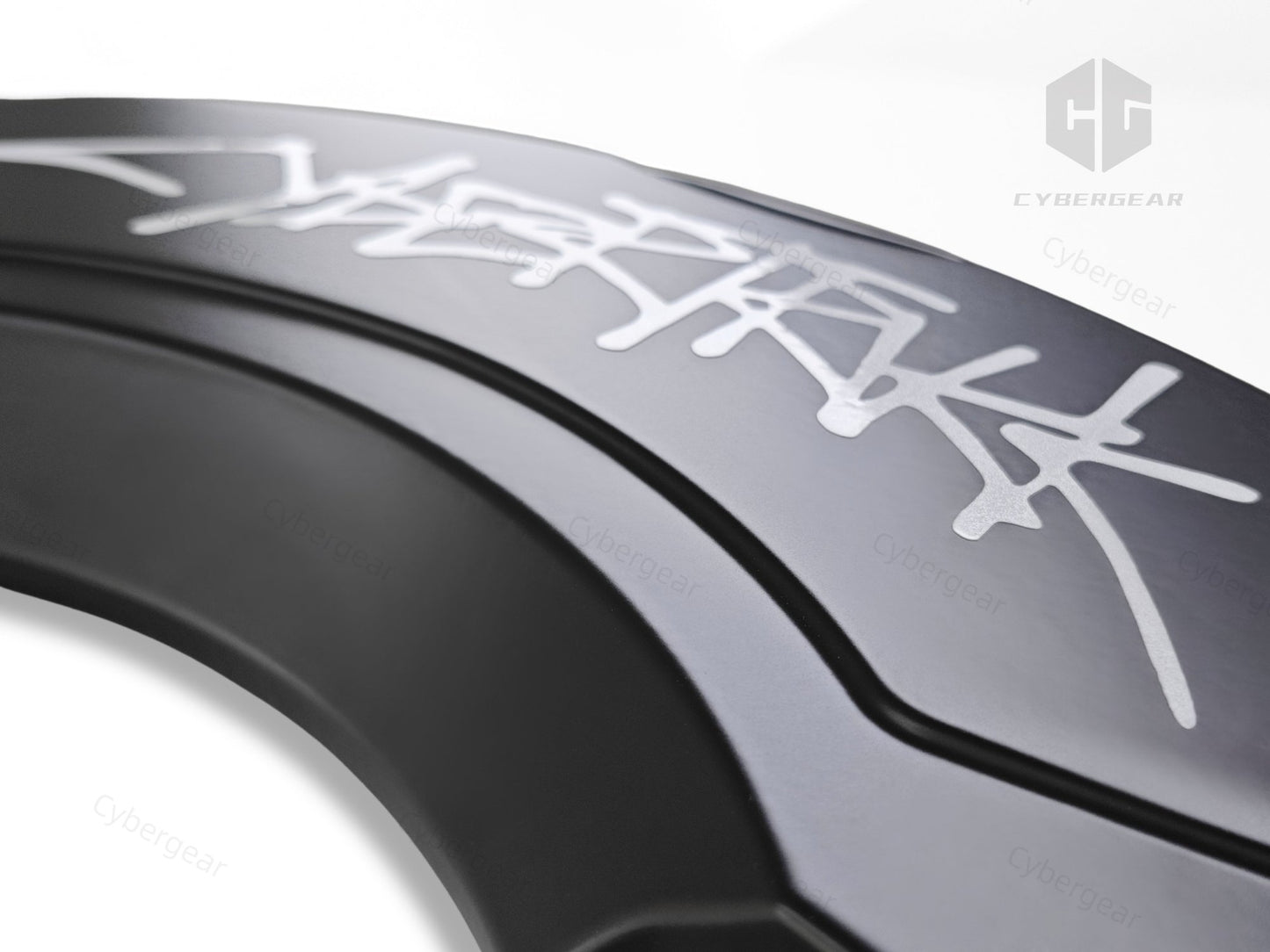 Close-up of a matte black Cybertruck caliper cover featuring a sleek silver graffiti-style logo design, highlighting premium craftsmanship and bold aesthetics