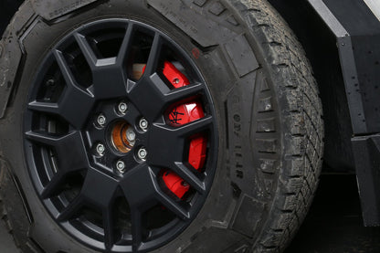 Tesla Cybertruck red caliper cover paired with black multi-spoke wheel and durable off-road tire, showcasing a sporty and personalized design.